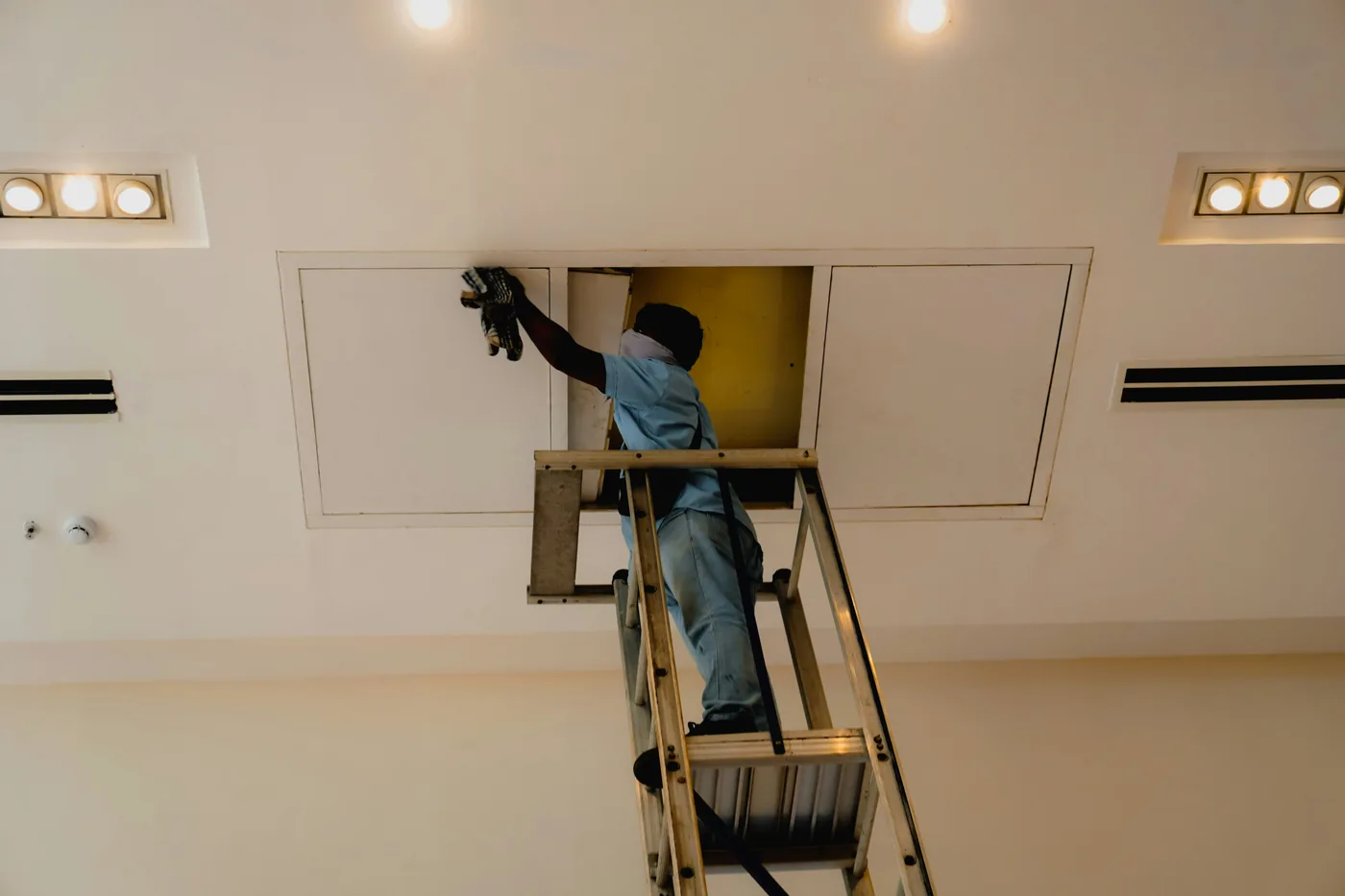 Building maintenance work being carried out on a ladder